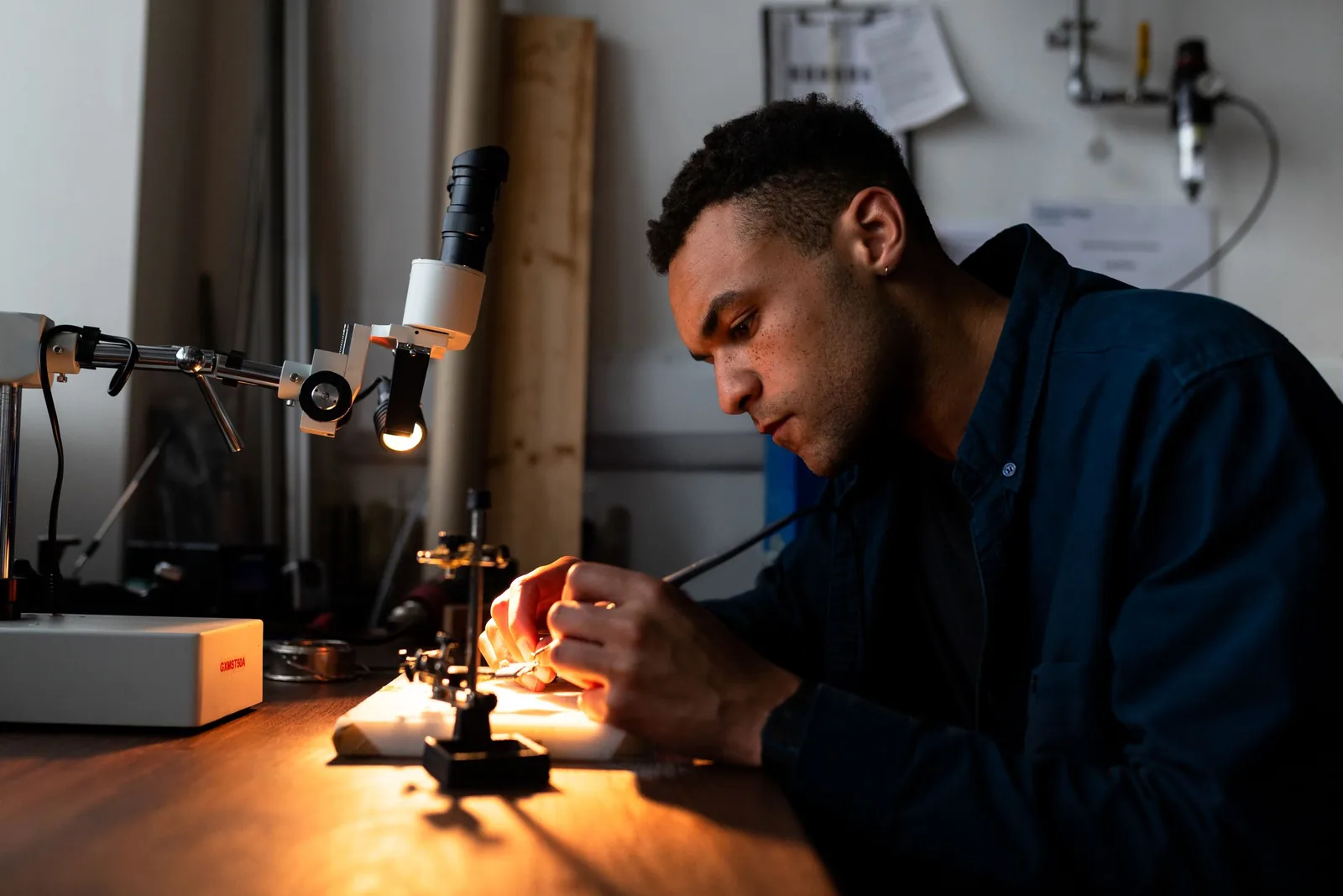 Black specialist carrying out precision work on mission-critical systems